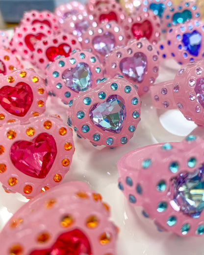 pink heart shaped rings with colorful crystals