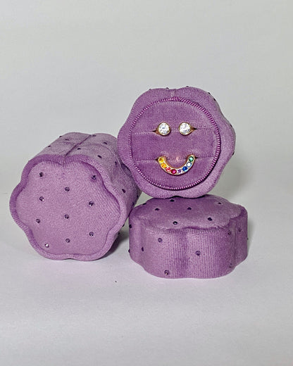 Three purple textured boxes with decorative elements on a light gray background